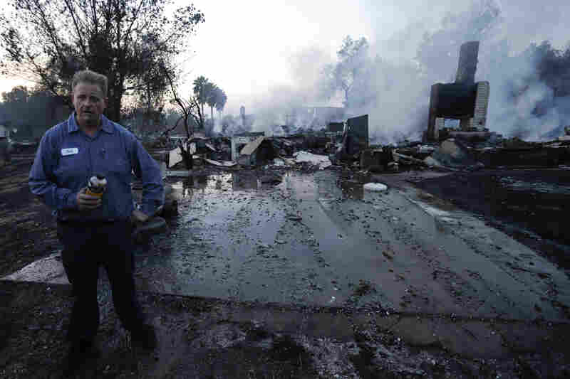 Jack Whitlang stands in front of his aunt's home, which burned to the foundation in the Escondido Fire.