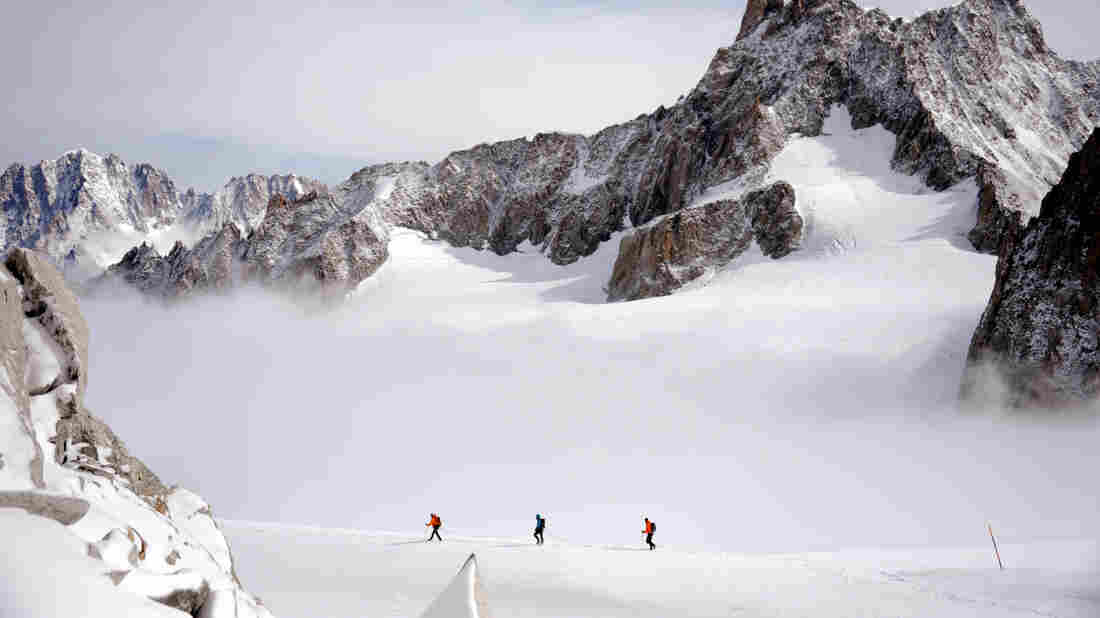 A rope of three climbers walk at 3400m on September 11, 2013 near the Dent du Géant (Giant's tooth), in the Mont Blanc massif in France and Italy.