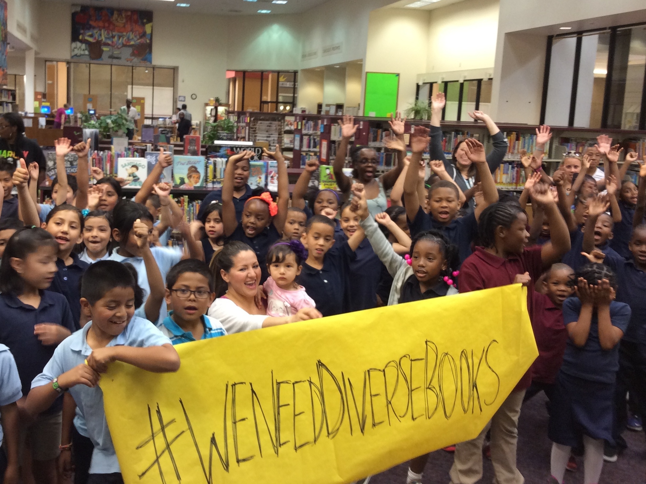 Children at Oakland Public Library in California participate in the #WeNeedDiverseBooks campaign. (Courtesy of Oakland Public Library)
