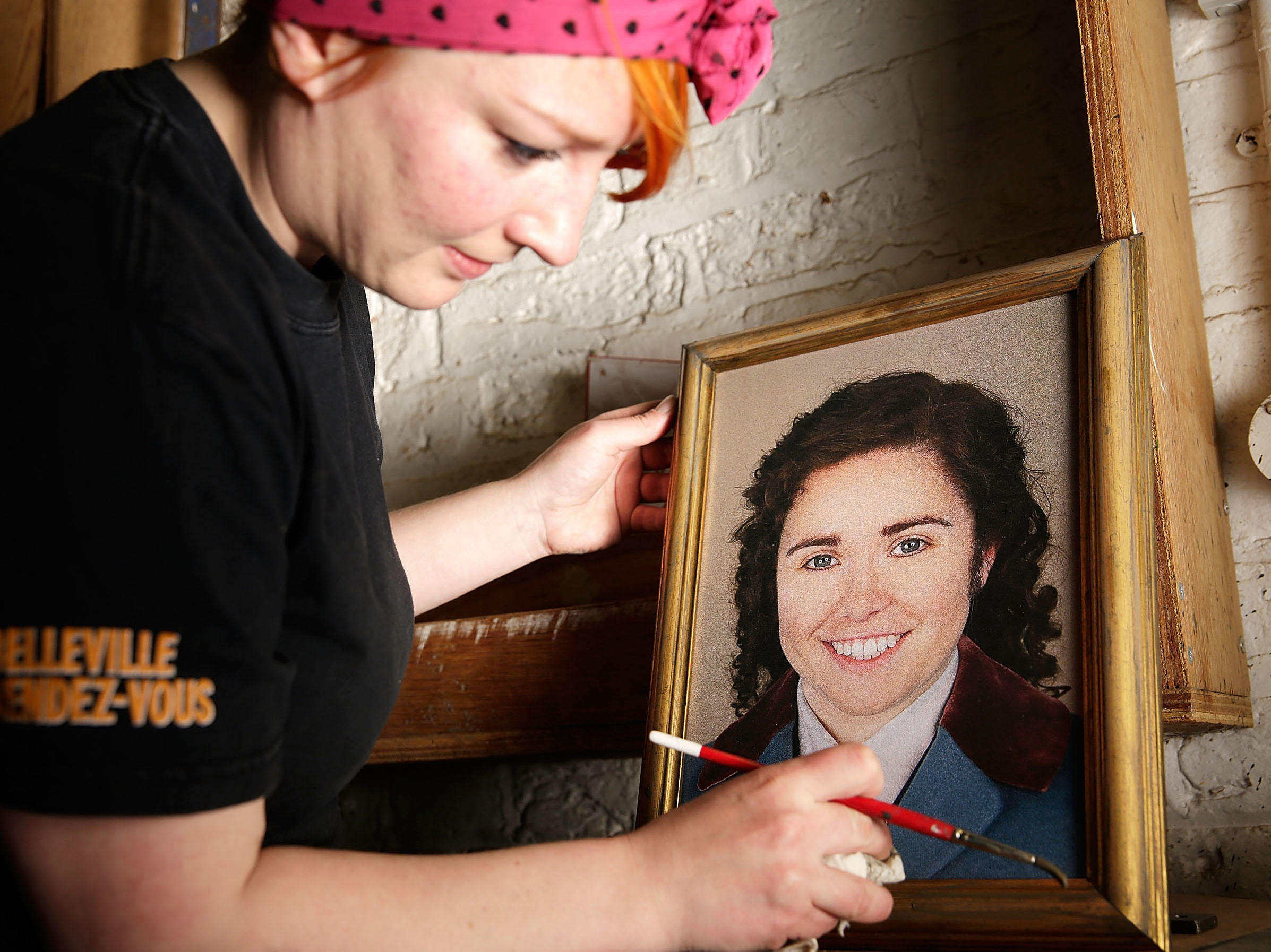 A prop maker readies a portrait of Octavian (Tara Erraught) in advance of the first performance of <em>Der Rosenkavalier </em>at the Glyndebourne Festival last month. (Getty Images)
