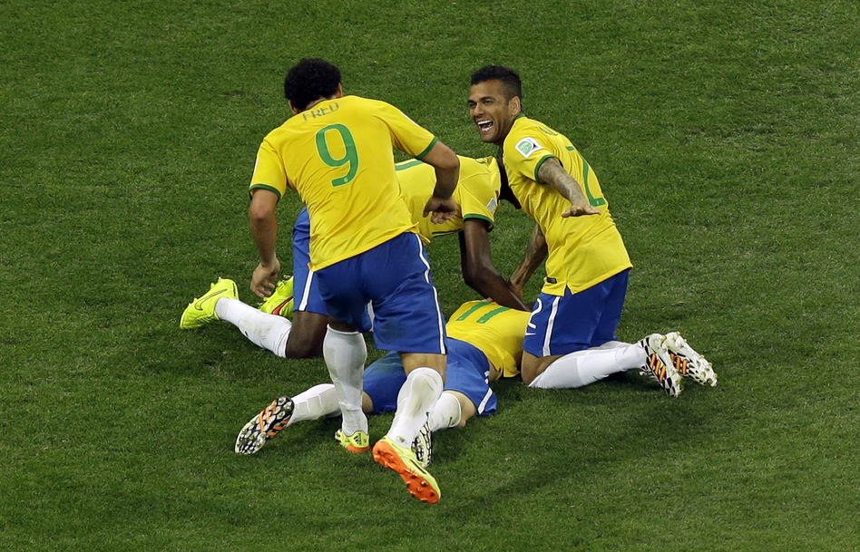 Members of Brazil's national team celebrate after scoring their third goal during the group A World Cup soccer match between Brazil and Croatia on Thursday. (Thanassis Stavrakis/AP)