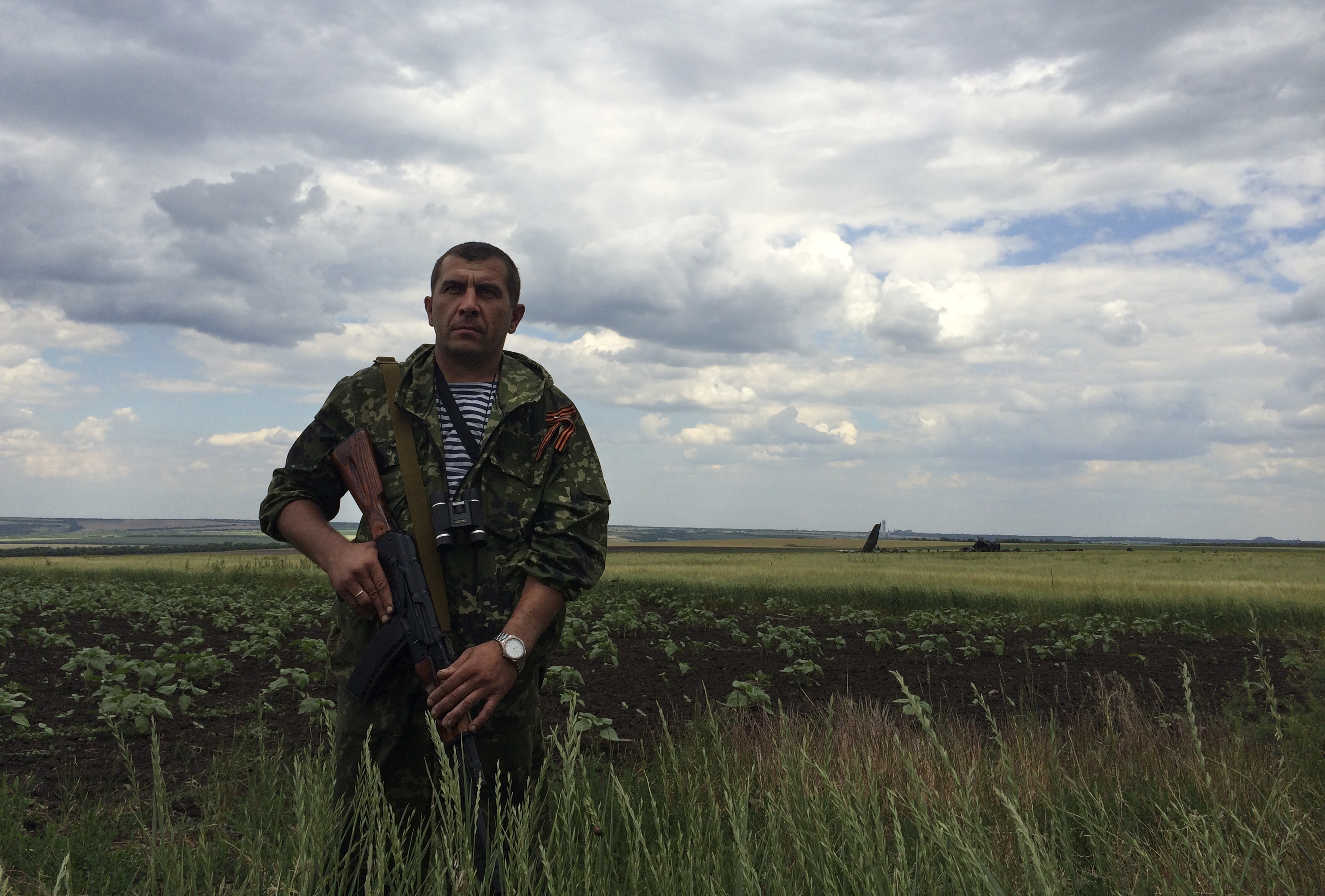 A pro-Russian fighter guards the site of remnants of a downed Ukrainian army aircraft near Luhansk, Ukraine on Saturday.