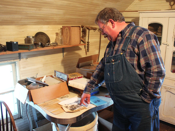 Donn Teske looks through family heirlooms in a house where his ancestors lived near Wheaton, Kans.