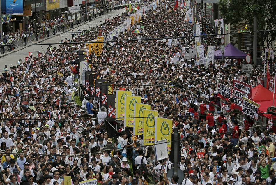 Tens of thousands of people march Tuesday in downtown Hong Kong during an annual protest pushing for greater autonomy. (Vincent Yu/AP)