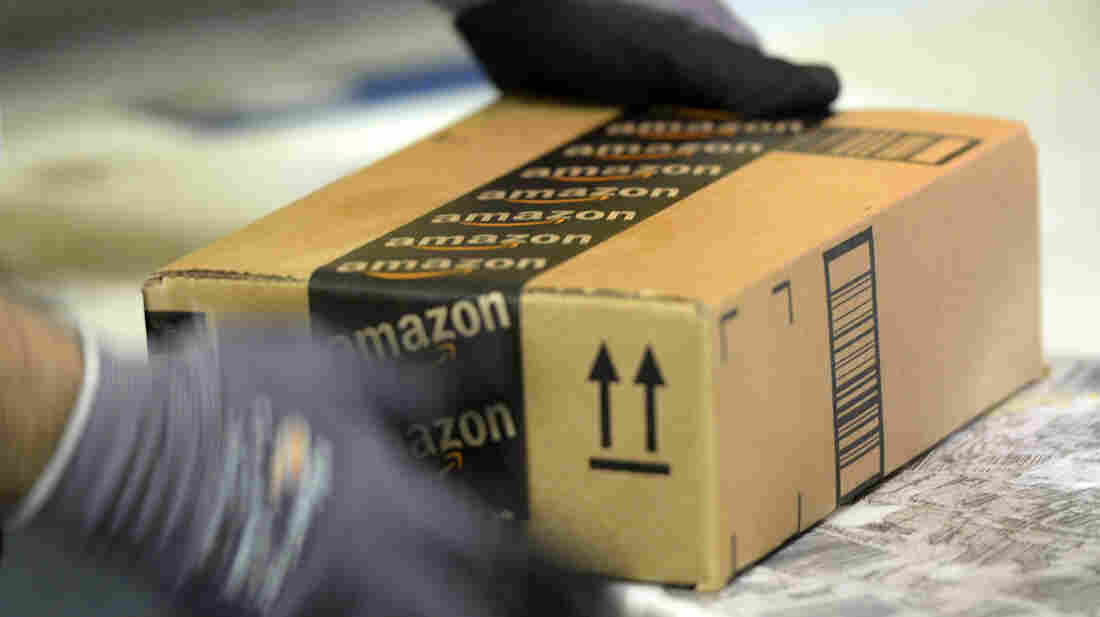 An employee prepares an order at Amazon's fulfillment center in San Bernardino, Calif.