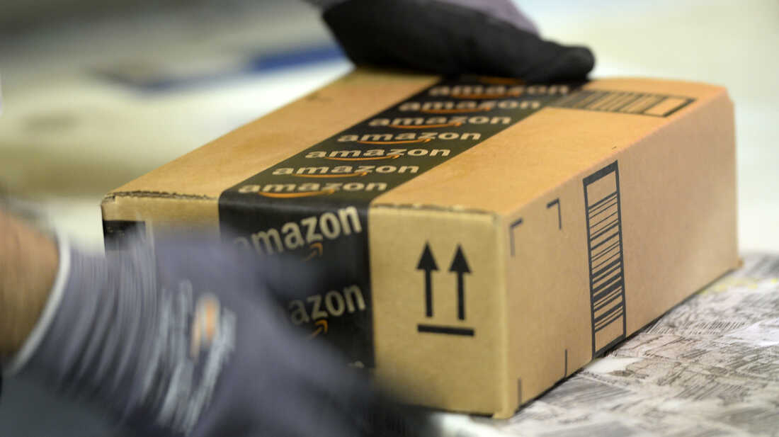 An employee prepares an order at Amazon's fulfillment center in San Bernardino, Calif.