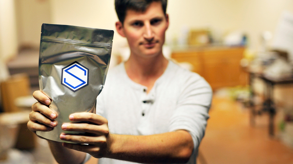 Soylent CEO Rob Rhinehart holds a bag of finished product in September 2013. Rhinehart recently discouraged members of the company's DIY online community from competing directly with Soylent.