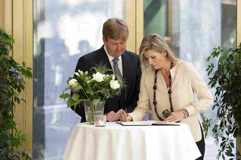 Dutch King Willem-Alexander and Queen Maxima sign a condolence register at the Ministry of Security and Justice in The Hague, Netherlands. More than half of Flight MH17's passengers were from the Netherlands.