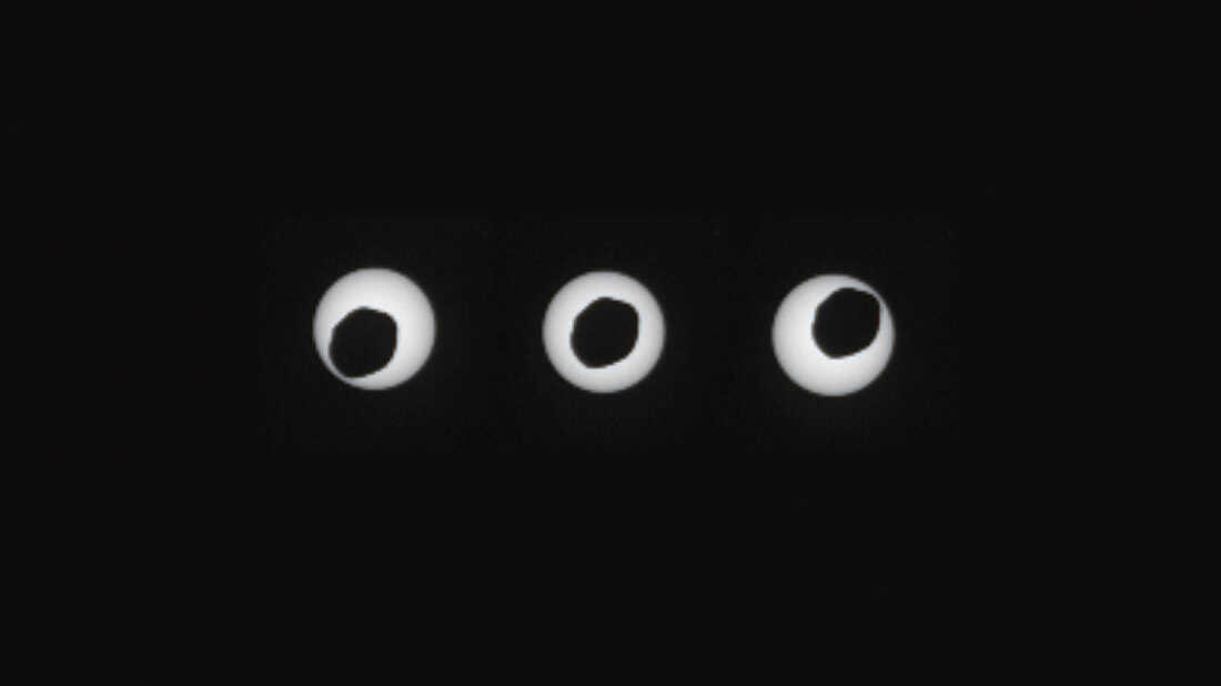A set of three images showing the larger of Mars' two moons, Phobos, passed directly in front of the sun as seen by NASA's Mars rover Curiosity.
