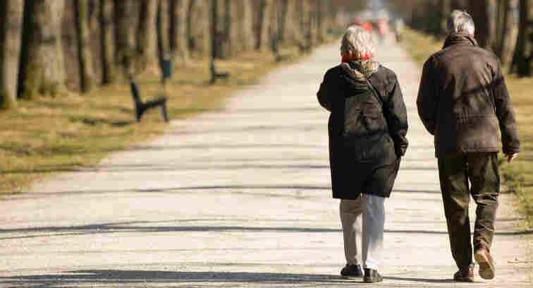 Two pensioners walking.