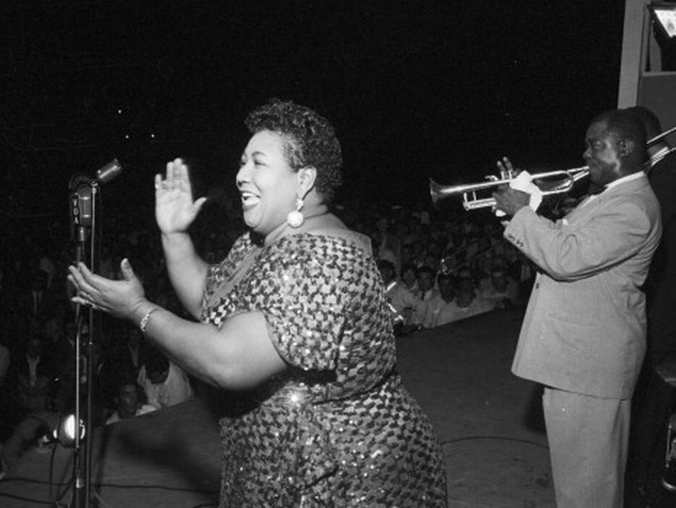Velma Middleton is accompanied by Louis Armstrong at the 1955 Newport Jazz Festival. (Paul S;ade/Getty)