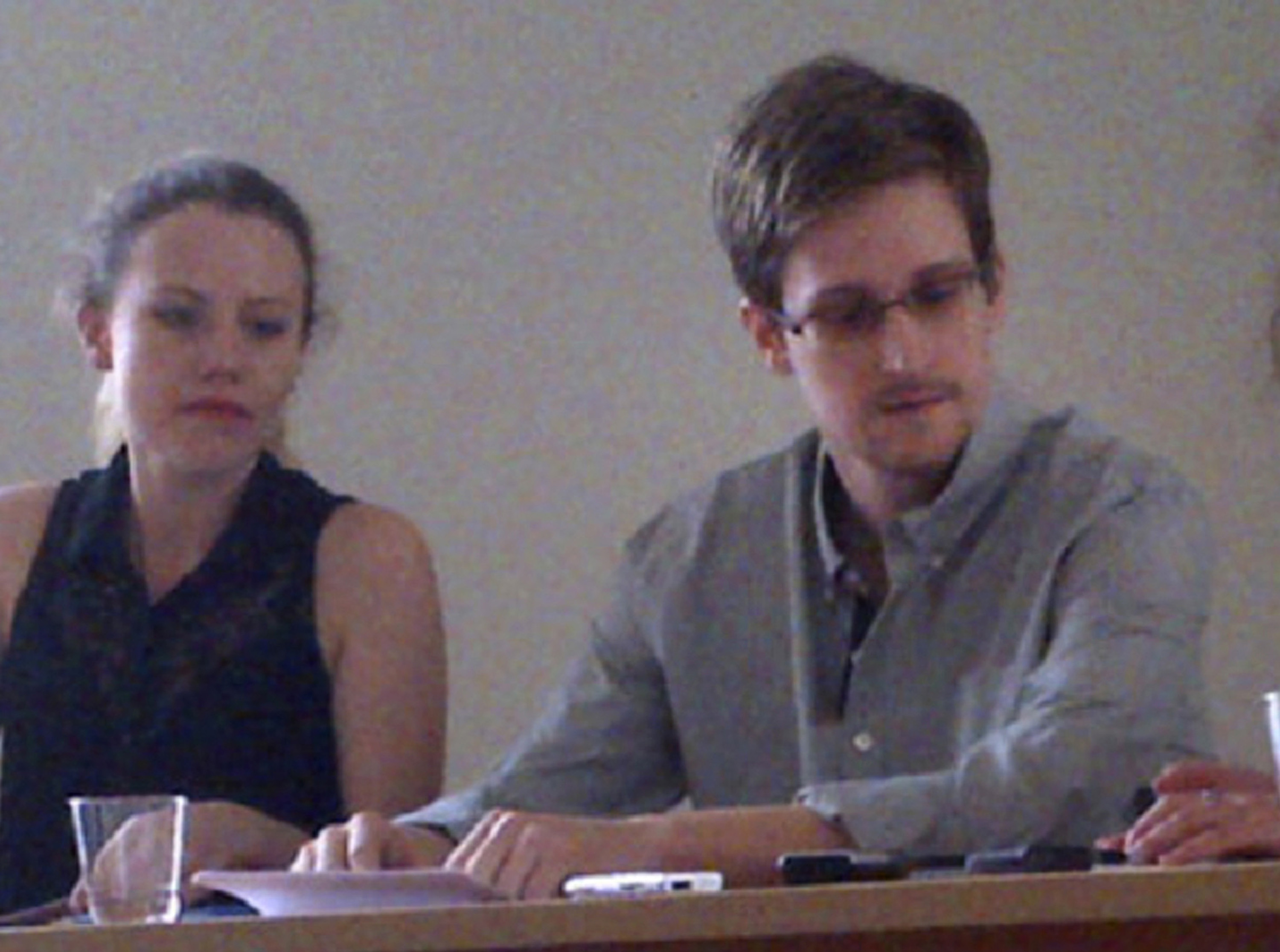 FILE - In this image provided by Human Rights Watch, NSA leaker Edward Snowden, center, attends a news conference at Moscow's Sheremetyevo Airport with in July of 2013.