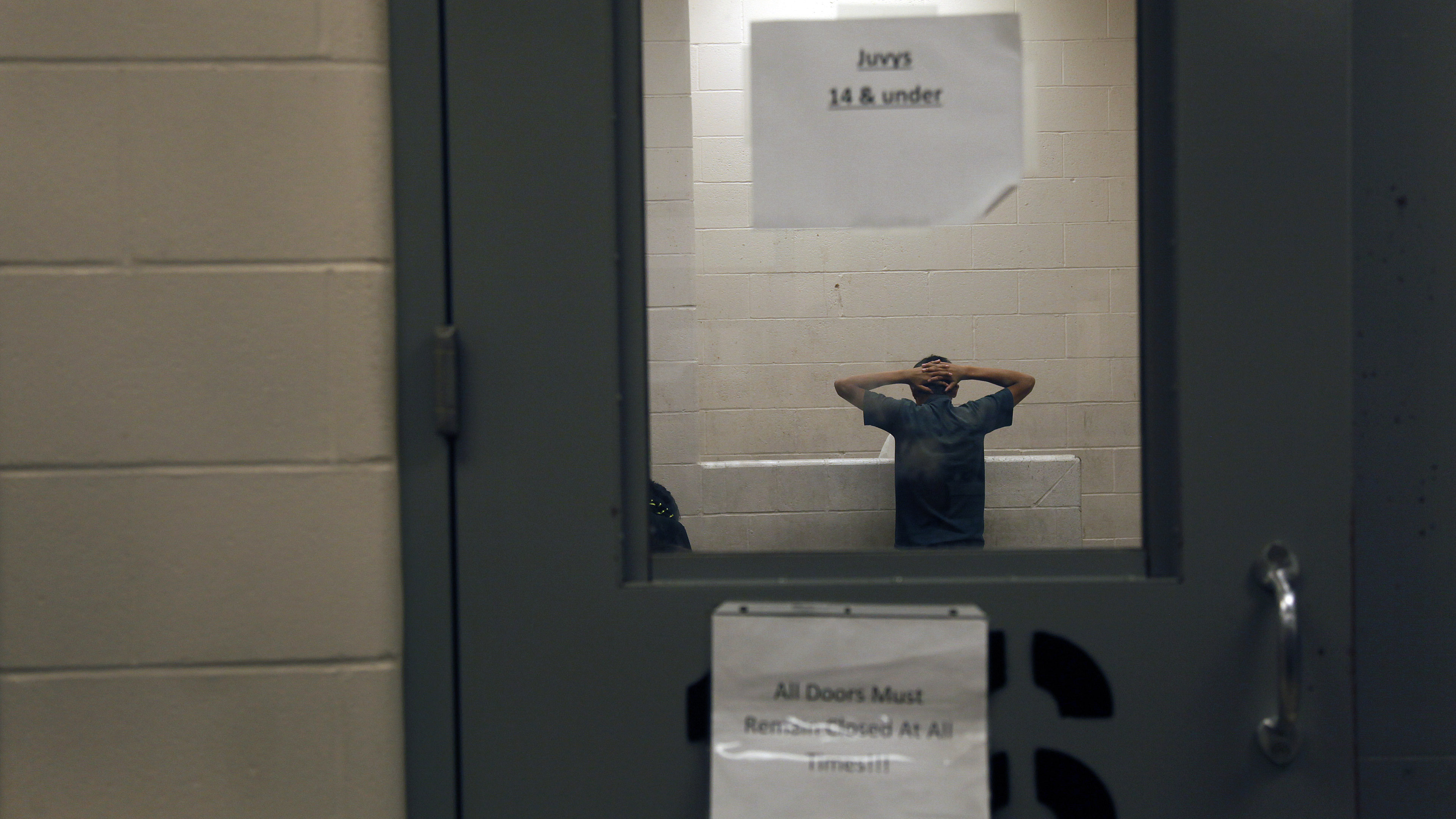 A young immigrant caught crossing the border illegally is housed inside the McAllen Border Patrol Station in McAllen, Texas, last month. (Getty Images)
