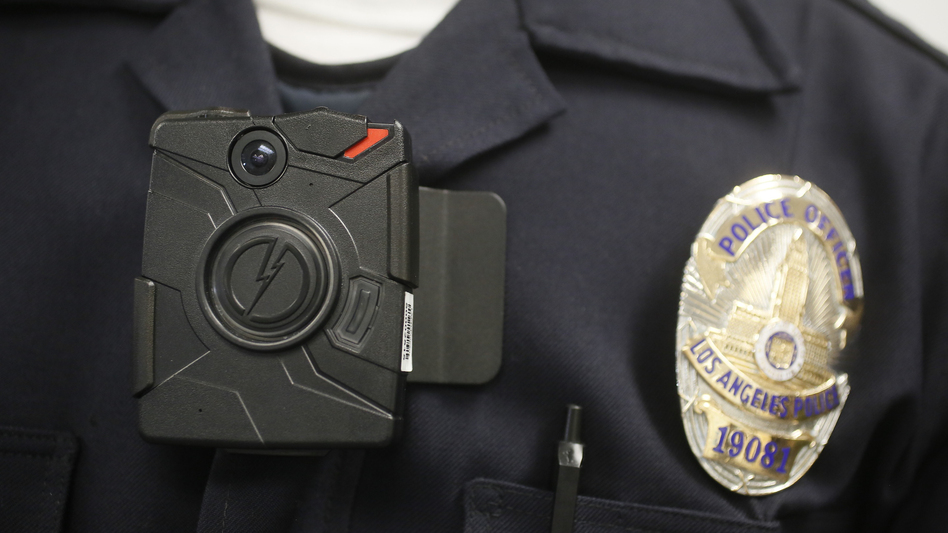 Many residents of Ferguson, Mo., would like to see the police wear video cameras, like this one worn by a Los Angeles police officer. (Damian Dovarganes/AP)