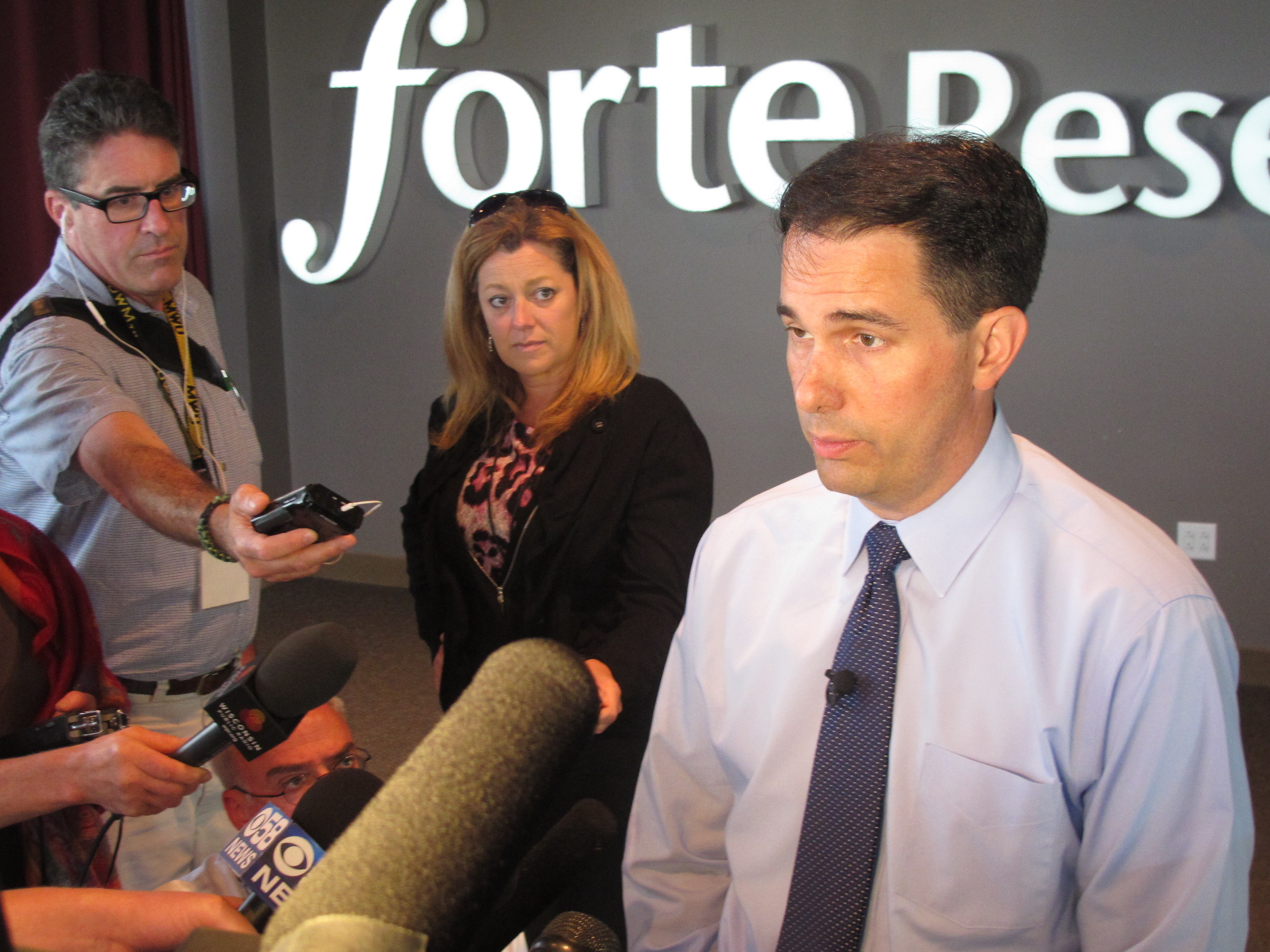 Gov. Scott Walker answers questions while celebrating the growth of local software company Forte Research Systems. He announced the company is adding 55 jobs with the help of a state loan.