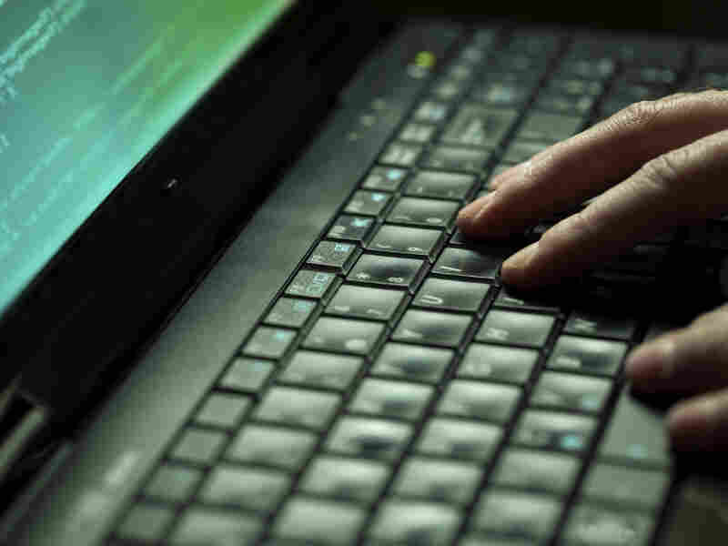 Fingers on a laptop keyboard