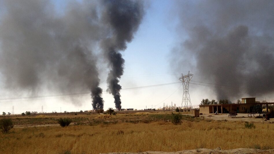 Smoke rises from the Beiji oil refinery during clashes between the Islamic State and Iraqi government forces in Beiji, northern Iraq, on July 30. The militants tried to take the refinery this summer, but government forces have held on. (STR/EPA/Landov)