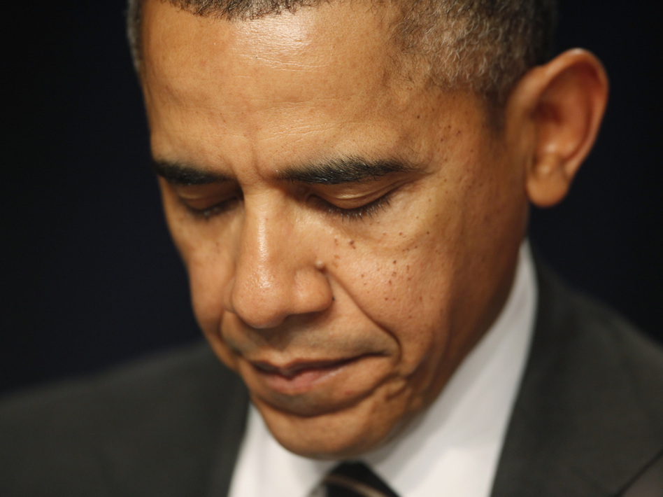 President Obama closes his eyes as a prayer is offered at the National Prayer Breakfast in February in Washington, D.C. (Charles Dharapak/AP)