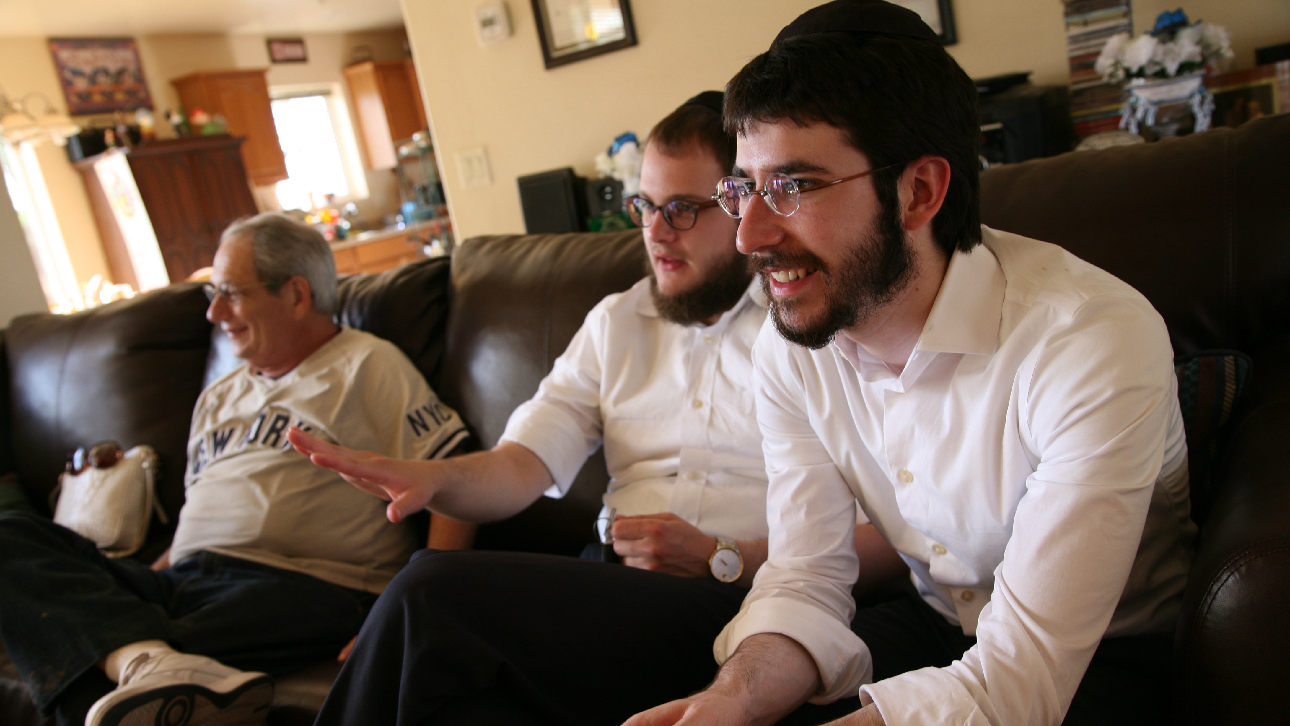 Chabad rabbinical students Zalman Refson (right) and Yaakov Kaplan sit alongside a Jewish resident of Taylor, Ariz. As roving rabbis, the duo recently went to about 40 tiny towns and cities across Arizona, meeting rural Jews along the way.