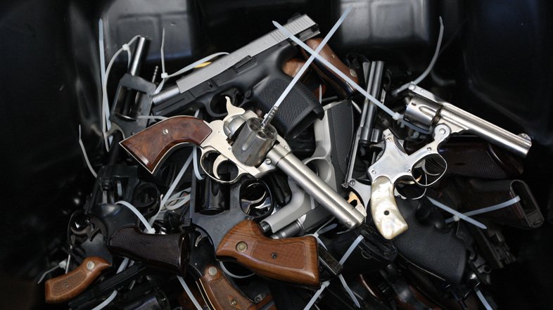 Surrendered handguns are piled in a bin during a gun buyback event in Los Angeles on May 31, 2014. (David McNew/Getty Images)