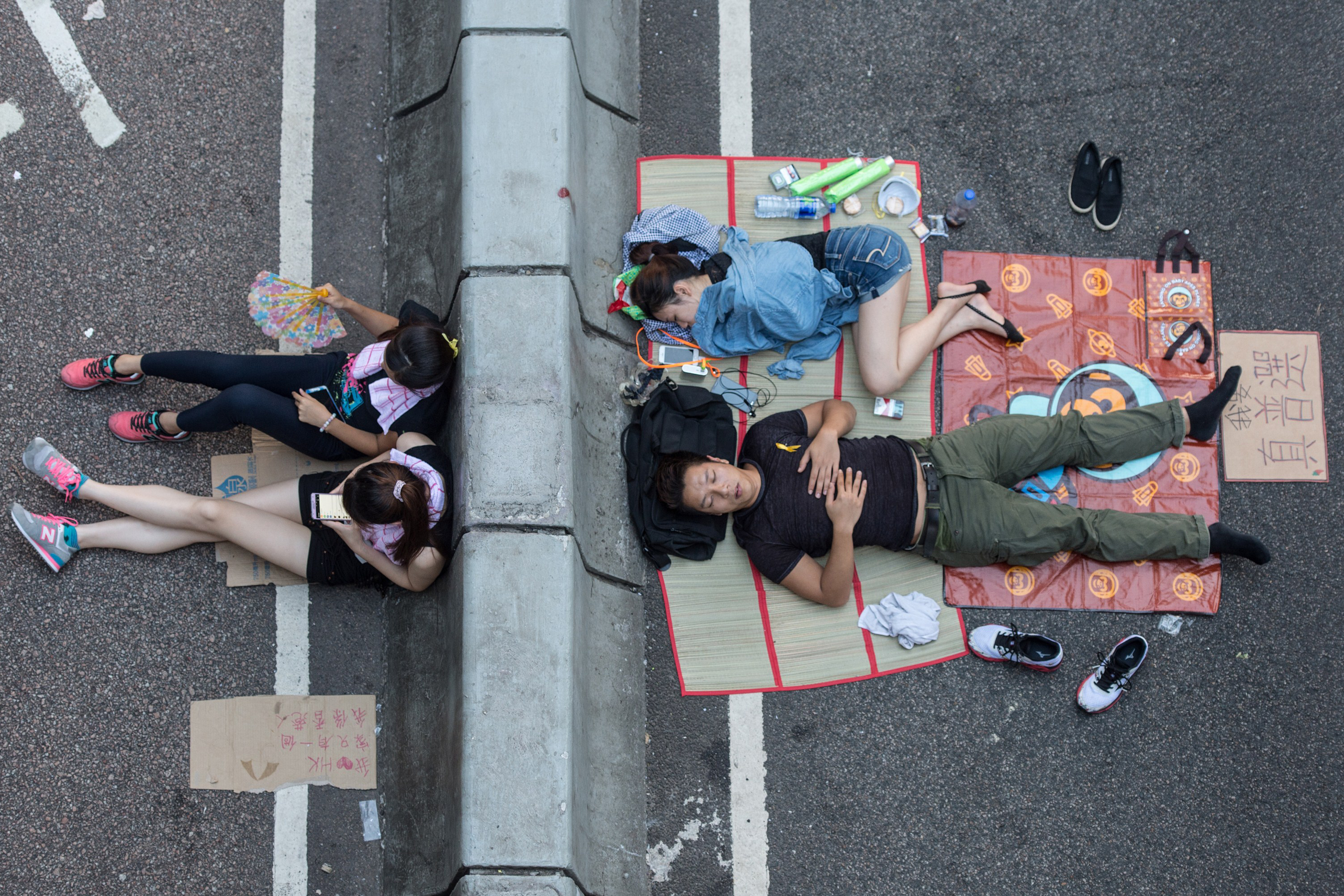 Pro-democracy protesters sleep on a street in Hong Kong.