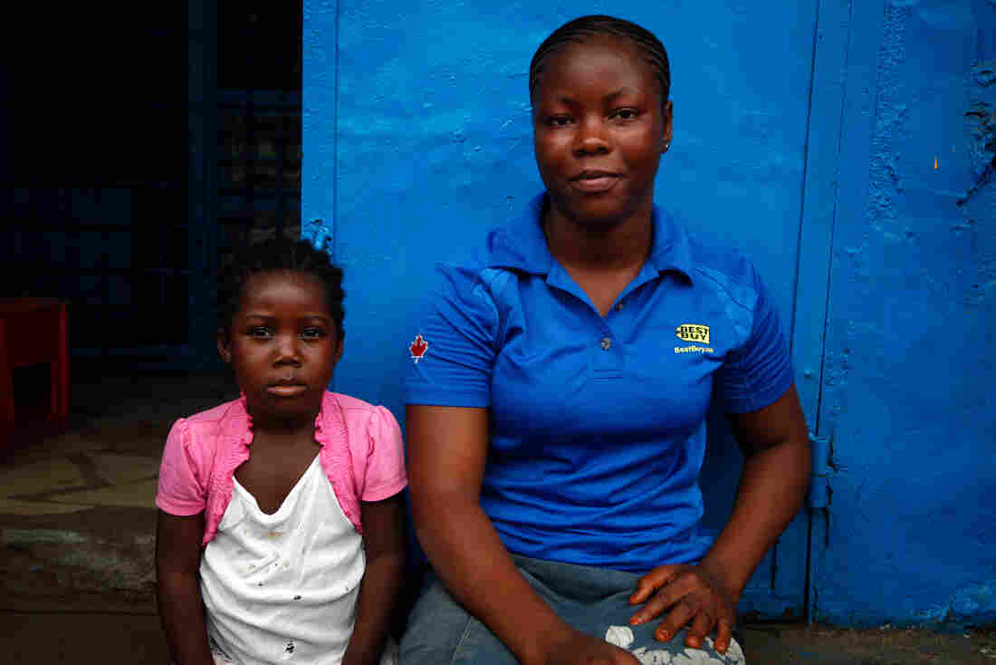 Koyapo Kannes, 21, waits for the bus with her family.