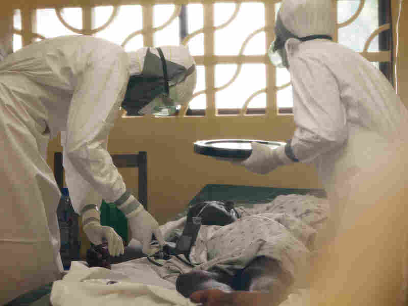 Dr. Kent Brantly, left, treats an Ebola patient at the Samaritan's Purse Ebola Case Management Center in Monrovia, Liberia. On Saturday, July 26, 2014, the North Carolina-based aid organization said Brantly tested positive for the disease and was being treated at a hospital in Monrovia.