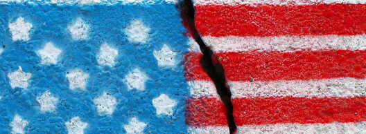 American flag painted on a cracked wall.