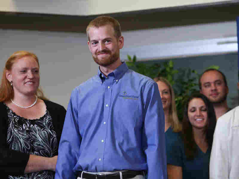 Dr. Kent Brantly (center), stands with his wife, Amber Brantly, during a press conference announcing his release from Emory Hospital on Aug. 21, 2014 in Atlanta, Georgia.
