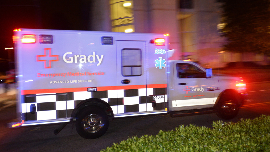 An ambulance carrying Amber Vinson, the second health care worker to be diagnosed with Ebola in Texas, arrives at Emory University Hospital in Atlanta on Wednesday. (David Tulis/AP)