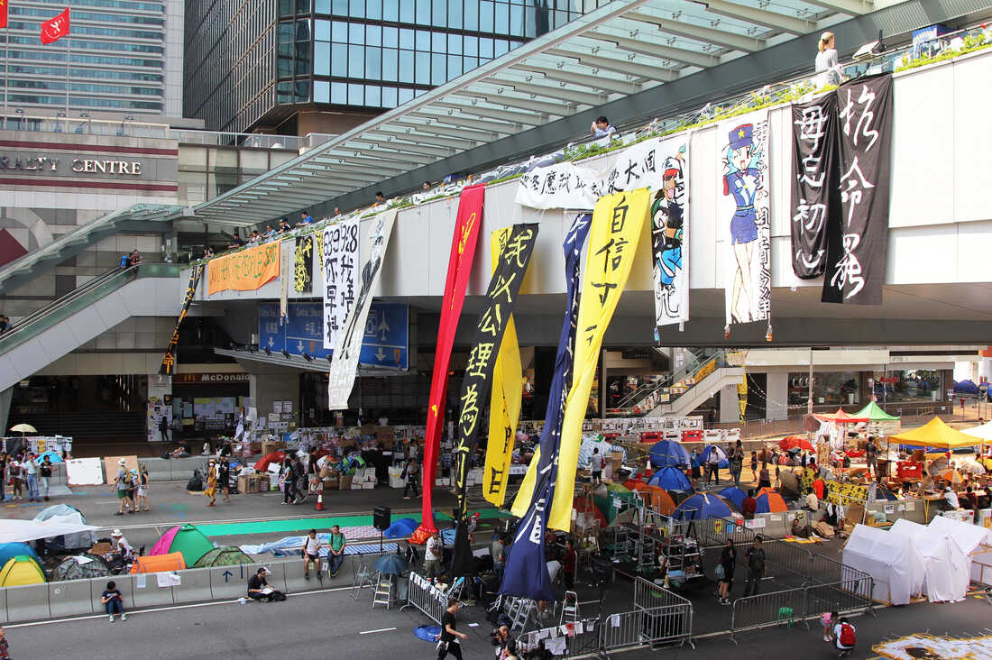 A pedestrian bridge over the main protest camp in Hong Kong's Admiralty district. The orange banner at the far left says, "Do You Hear The People Sing?" the title of a song from Les Miserables, the musical set in 19th-century, revolutionary-era France.