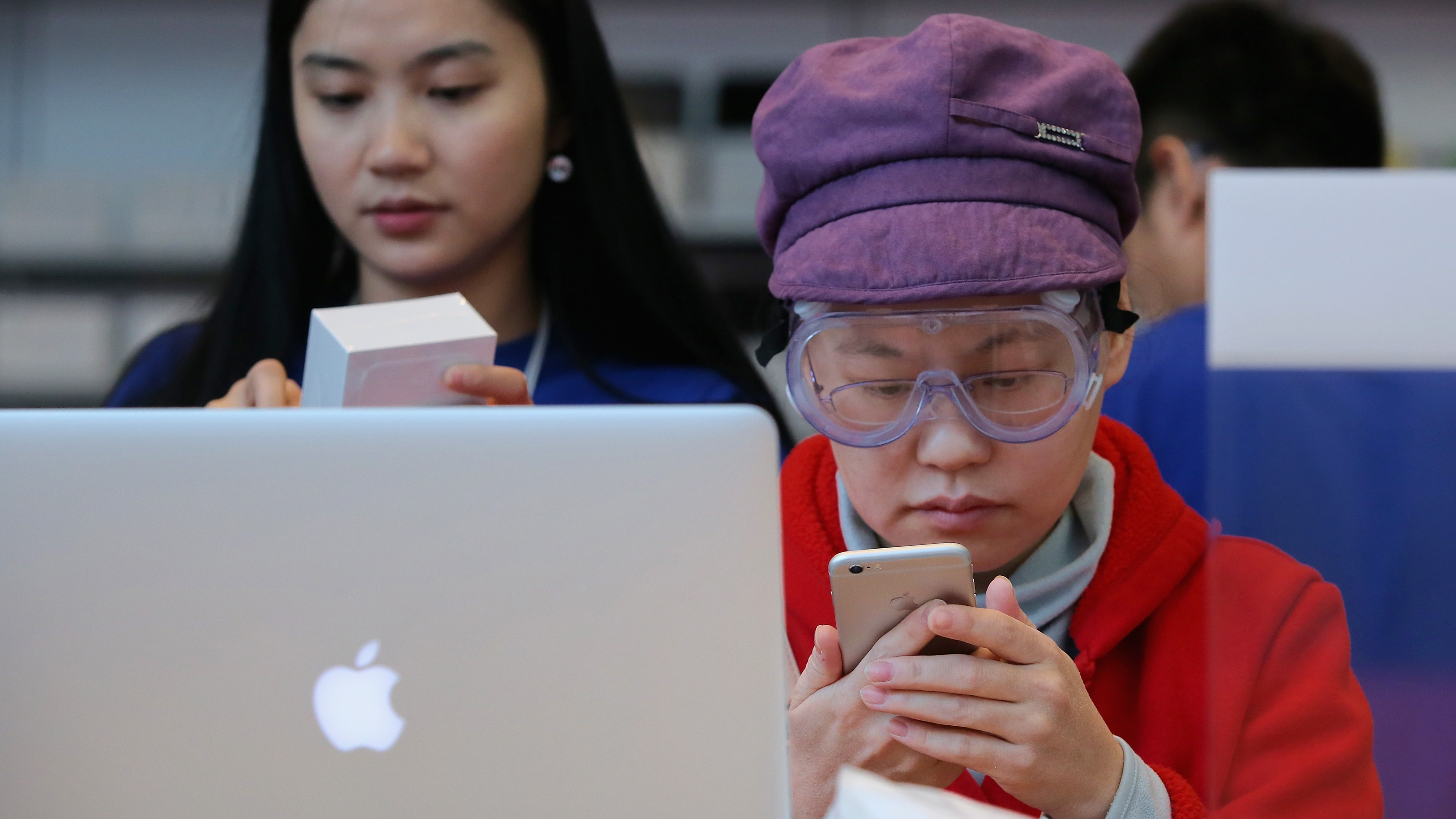 A customer sets up her new iPhone 6 at an Apple store in Beijing on Friday. A group says the Chinese government backed an attack against users of Apple's iCloud service, but the government denies the claim. (Getty Images)