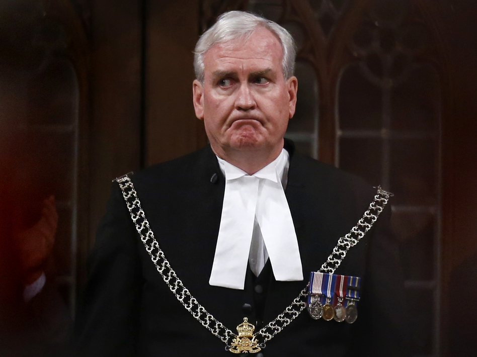 Sergeant-at-Arms Kevin Vickers is applauded in the House of Commons in Ottawa on Thursday. Vickers was credited with shooting the suspect during an attack on the Parliament complex on Wednesday. (Chris Wattie/Reuters/Landov)