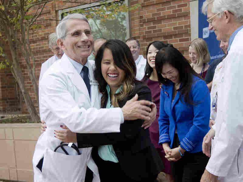 Patient Nina Pham is hugged by Dr. Anthony Fauci, director of the National Institute of Allergy and Infectious Diseases outside of National Institutes of Health (NIH) in Bethesda, Md., on Oct. 24, 2014. Pham, the first nurse diagnosed with Ebola after treating an infected man at a Dallas hospital is free of the virus.