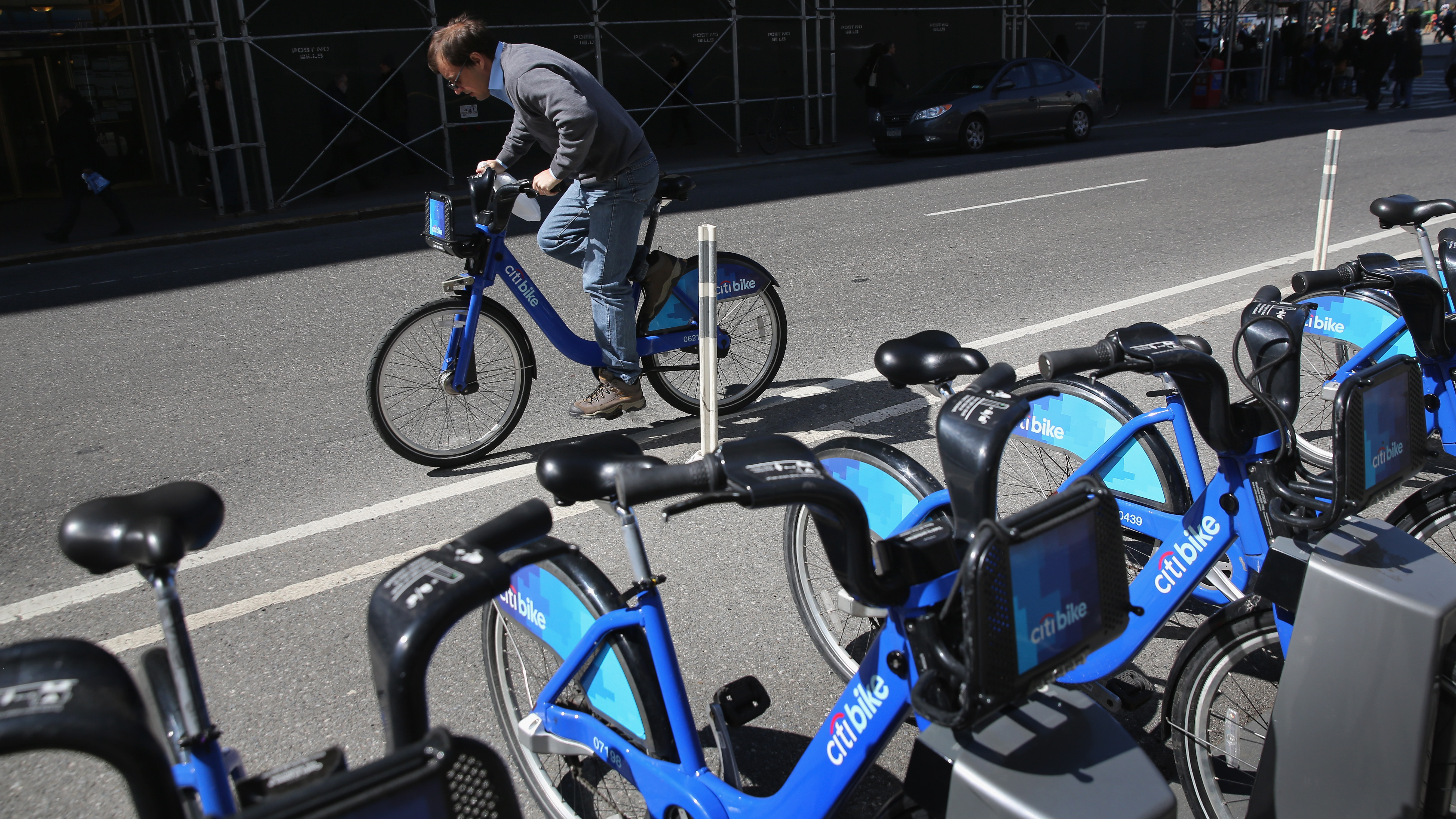 A Citi Bike user pedals off from a bicycle station. The company that owns the service in New York and other cities has been sold, after suffering problems tied to its supply chain and the weather. (Getty Images)