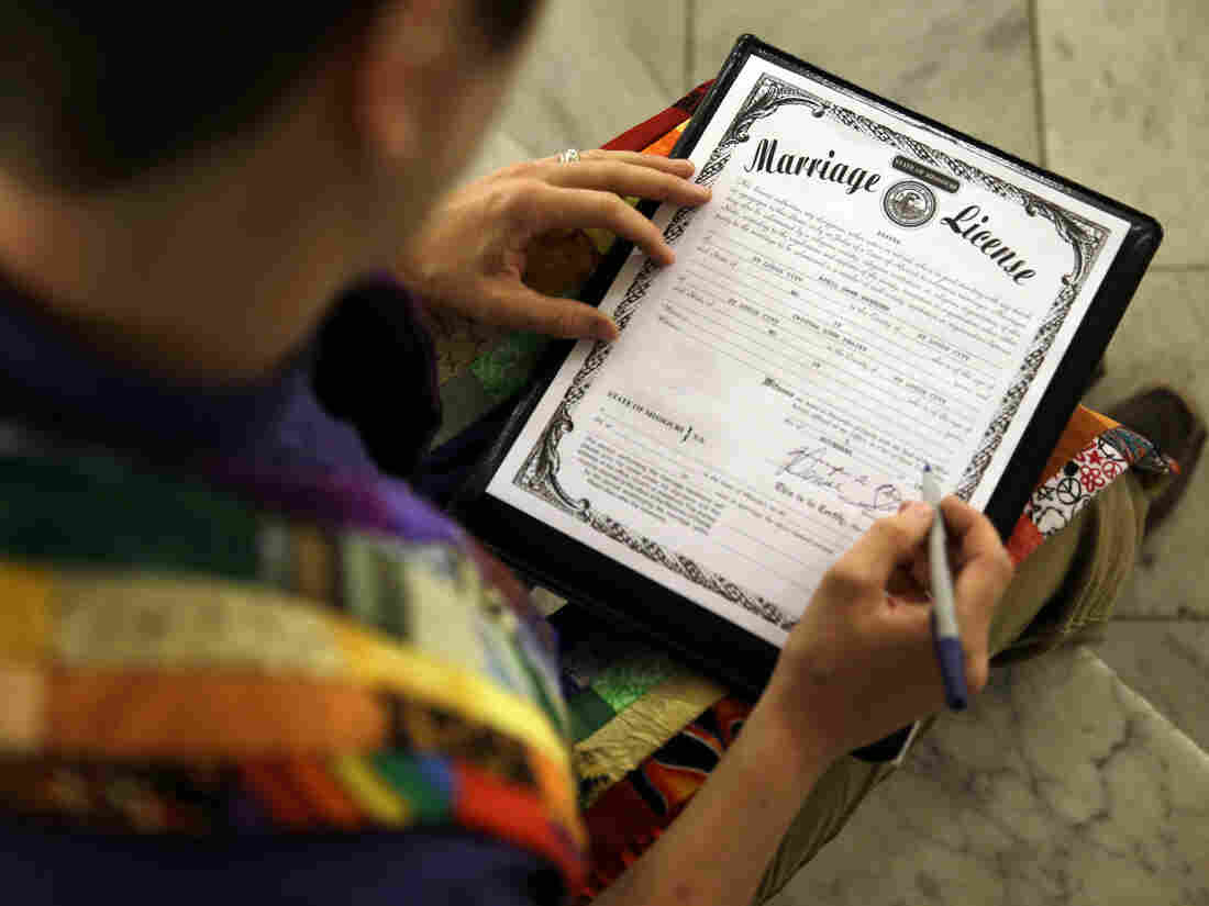 The Rev. Katie Hotze-Wilton signs a Missouri marriage license after performing a ceremony on Nov. 5 in St. Louis.