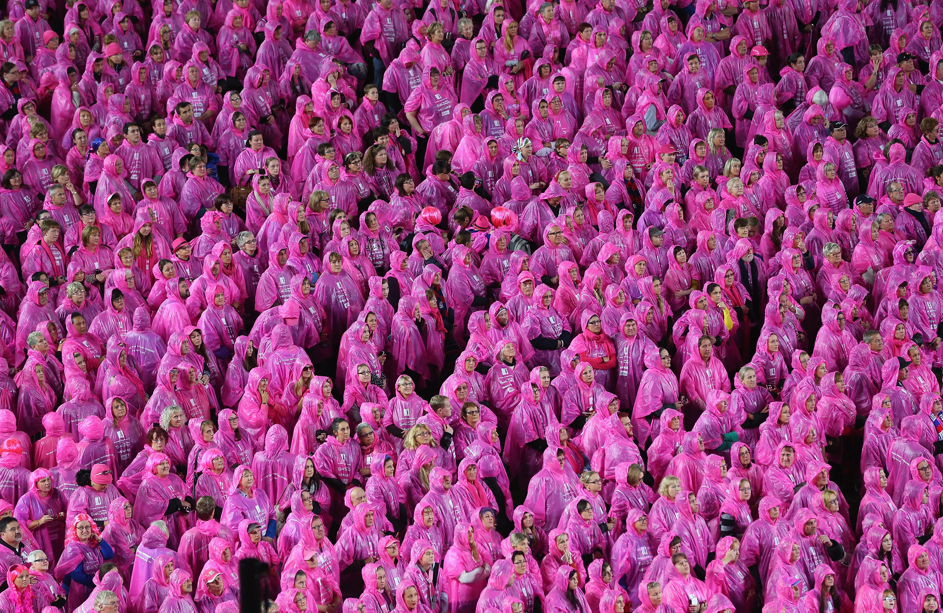 Spectators dressed in pink form the shape of a pink lady for breast cancer awareness in Melbourne, Australia. There was a backlash when pink was chosen as the symbolic color of breast cancer.