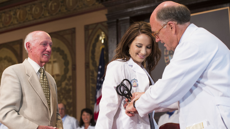Victoria Elizabeth Fischer was presented with a white coat by her grandfather, Dr. Christian Van Den Heuvel, at Georgetown University School of Medicine in August. The ceremony marks the start for each new class of medical students. (Lisa Helfert/Courtesy of Georgetown University)
