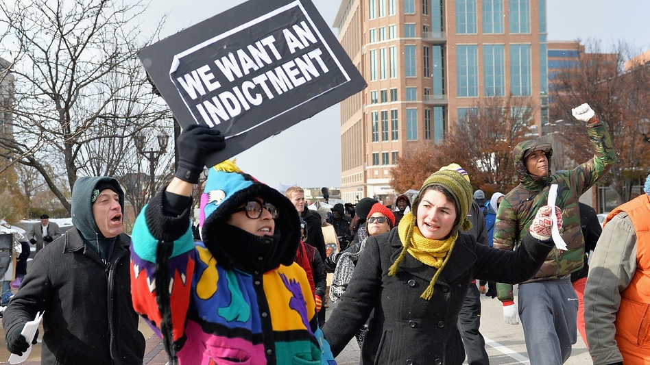 Protesters march in Clayton, Mo., Monday. Gov. Jay Nixon declared a state of emergency and activated the National Guard ahead of a grand jury decision in the case of Michael Brown, a black teenager shot and killed by a white police officer in August. (Michael B. Thomas/AFP/Getty Images)