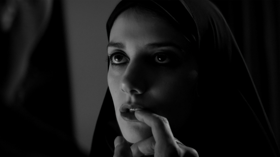 In <em>A Girl Walks Home Alone At Night</em>, Sheila Vand plays a vampire who wanders a town called, of all things, Bad City. (Kino Lorber Inc. )