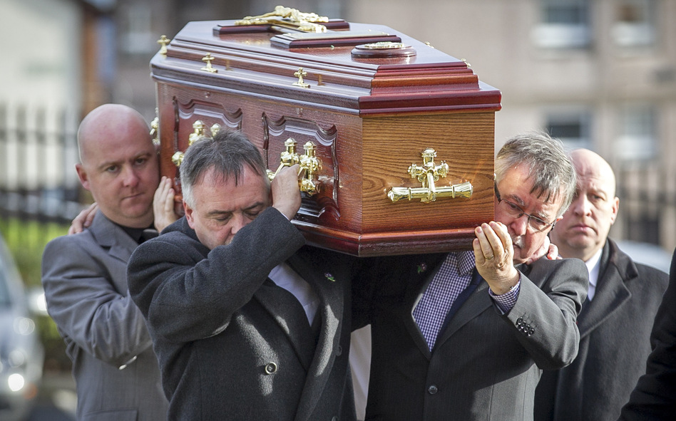 The remains of Brendan Megraw are carried to St. Oliver Plunkett Church in Belfast by his brothers Kieran (second left) and Sean (second right) on Nov. 14. The remains were found in a bog 36 years after Megrew was taken by the IRA. He was one of the many who died or disappeared during the decades-long Troubles between Protestant loyalists and Catholic republicans in Northern Ireland. (Liam McBurney/PA Photos/Landov)