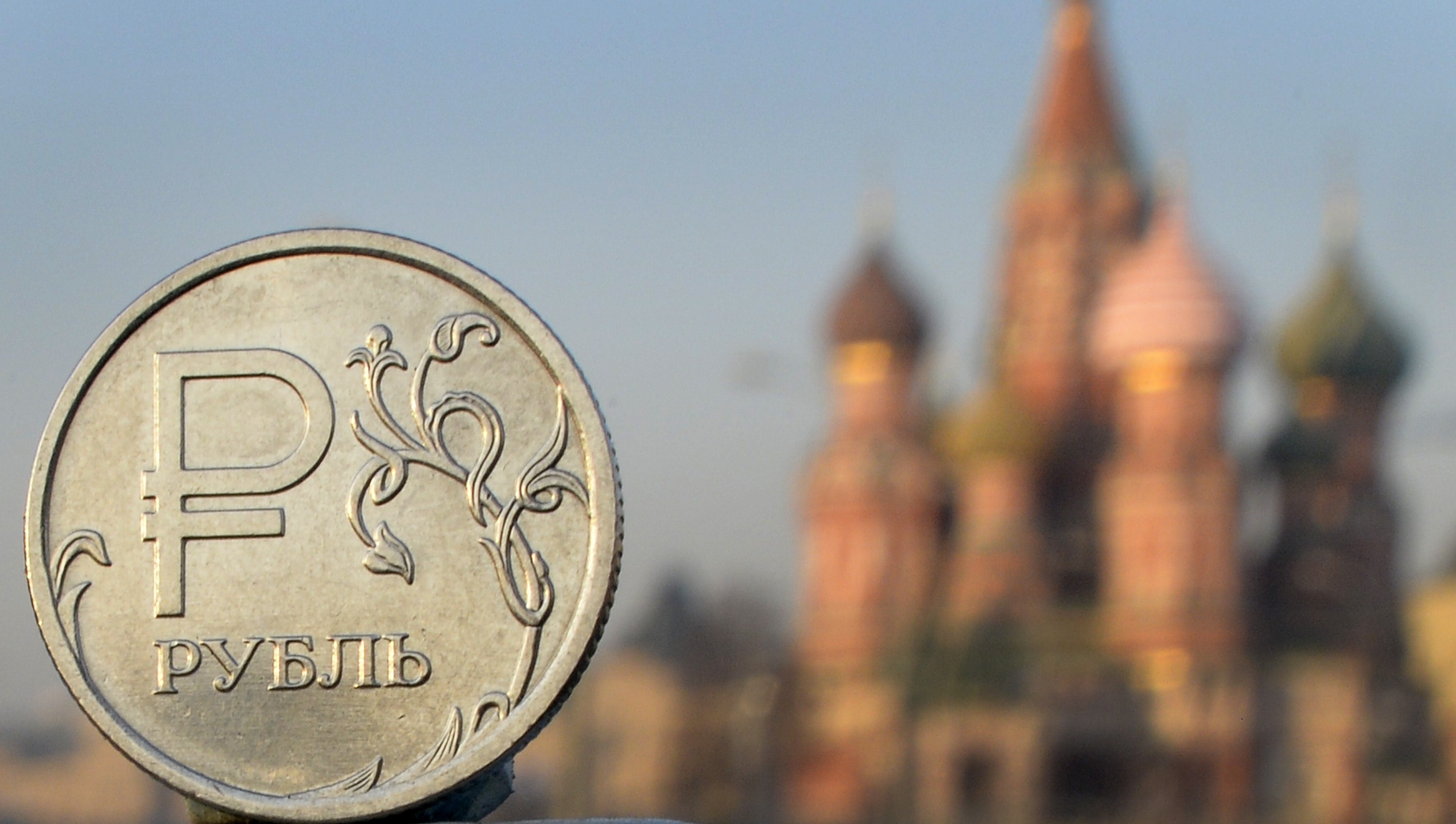 A Russian ruble coin is pictured in front of St. Basil cathedral in central Moscow, on November 20, 2014. (AFP/Getty Images)