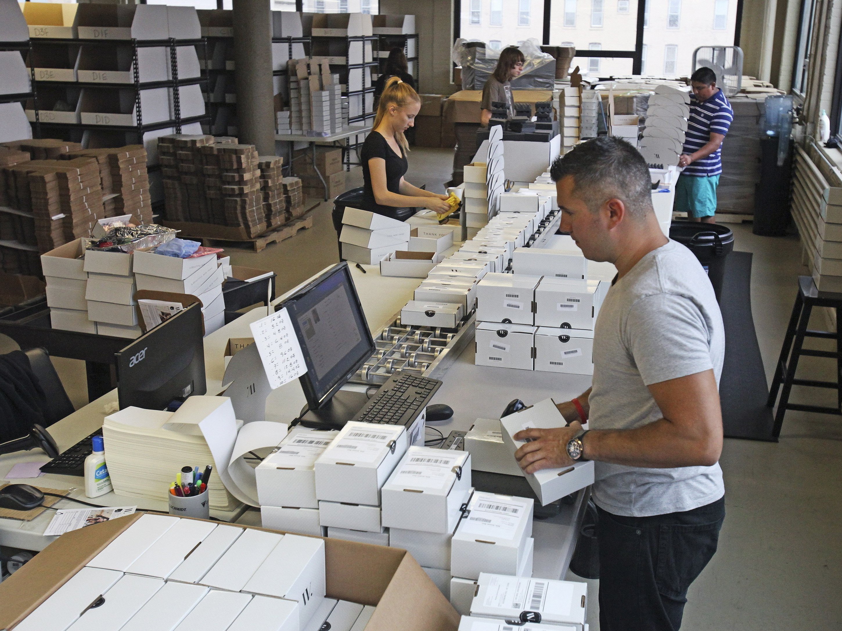 Employees work fill, label and packaging each personalized box Aug. 12 inside the distribution room at Wantable in Milwaukee.