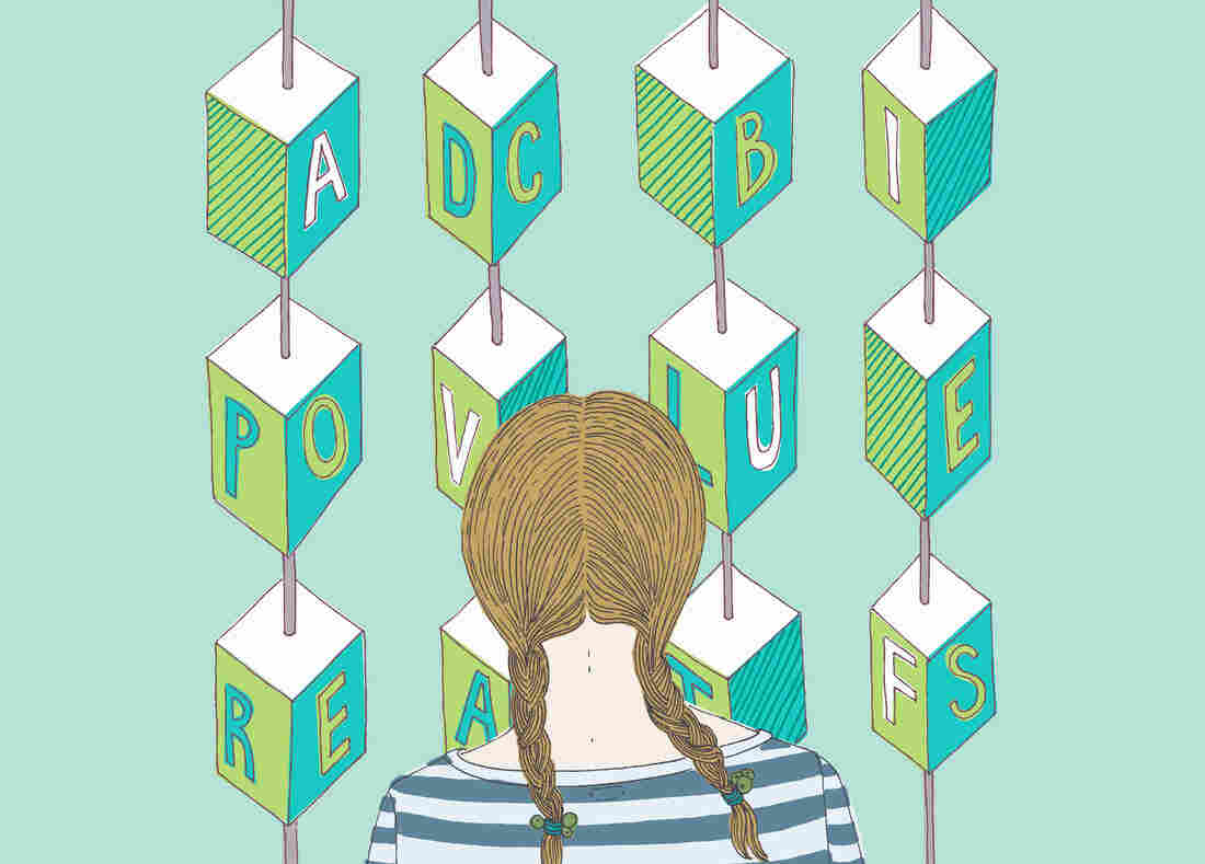 Girl looking at alphabet blocks --- Image by © Trina Dalziel/Ikon Images/Corbis