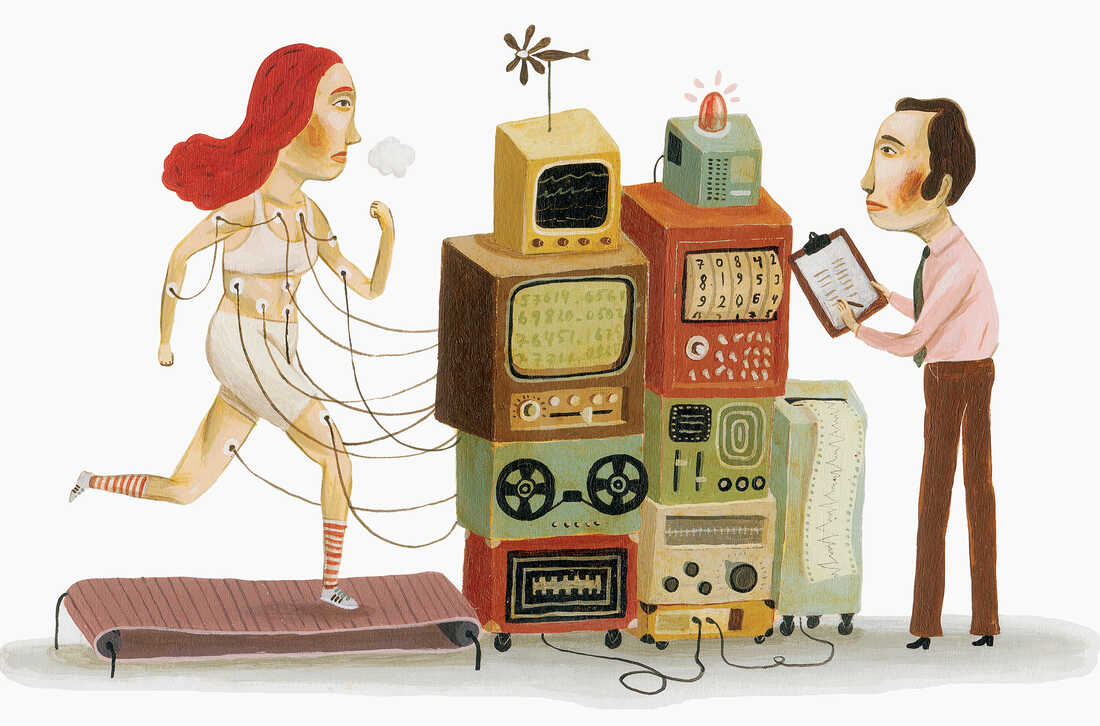 Woman running on treadmill connected to machines --- Image by © Ikon Images/Corbis