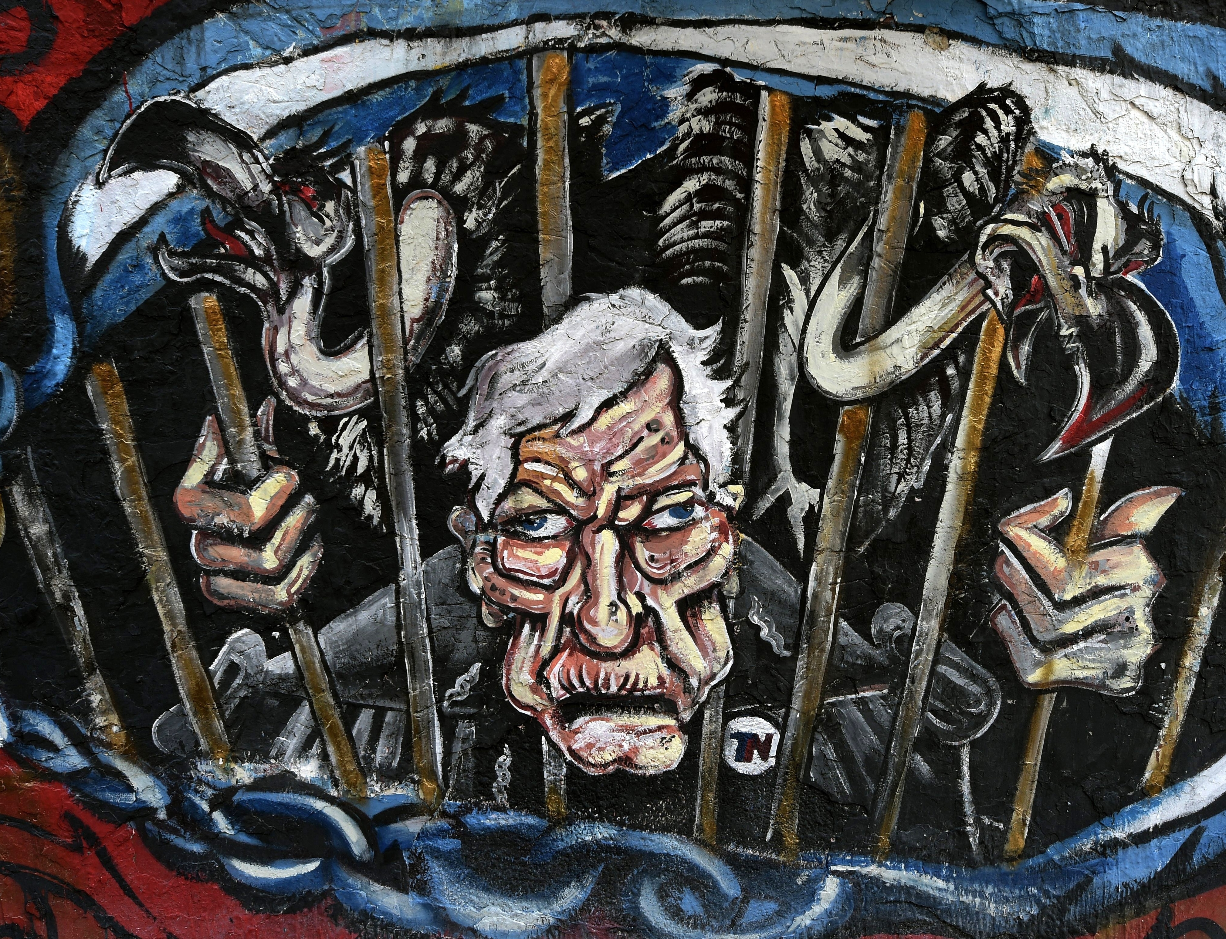 Graffiti in Buenos Aires depicts Griesa and vultures behind bars.