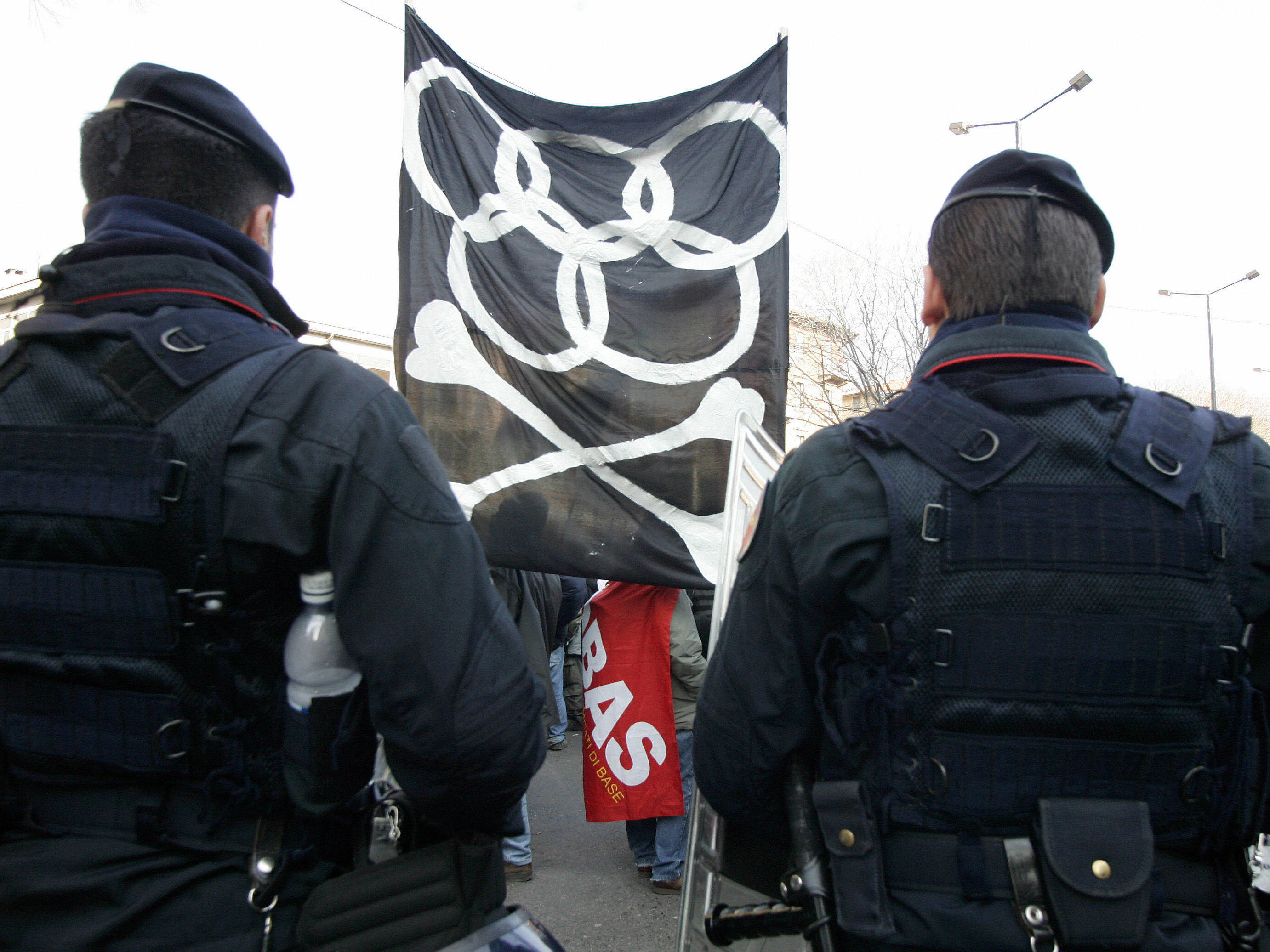 Italian military police officers stand in front of anti-Olympics demonstrators in February 2006 in Turin, Italy, on the eve of the opening ceremony of the 2006 Winter Games.
