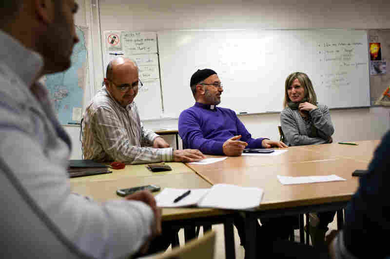 Saad Shamoon Moshi (left), Father Stefan Ayoub, and Swedish teacher Marie Silén in the Swedish language class for immigrants. Even by Swedish standards, Sodertalje has been exceptionally welcoming to refugees.