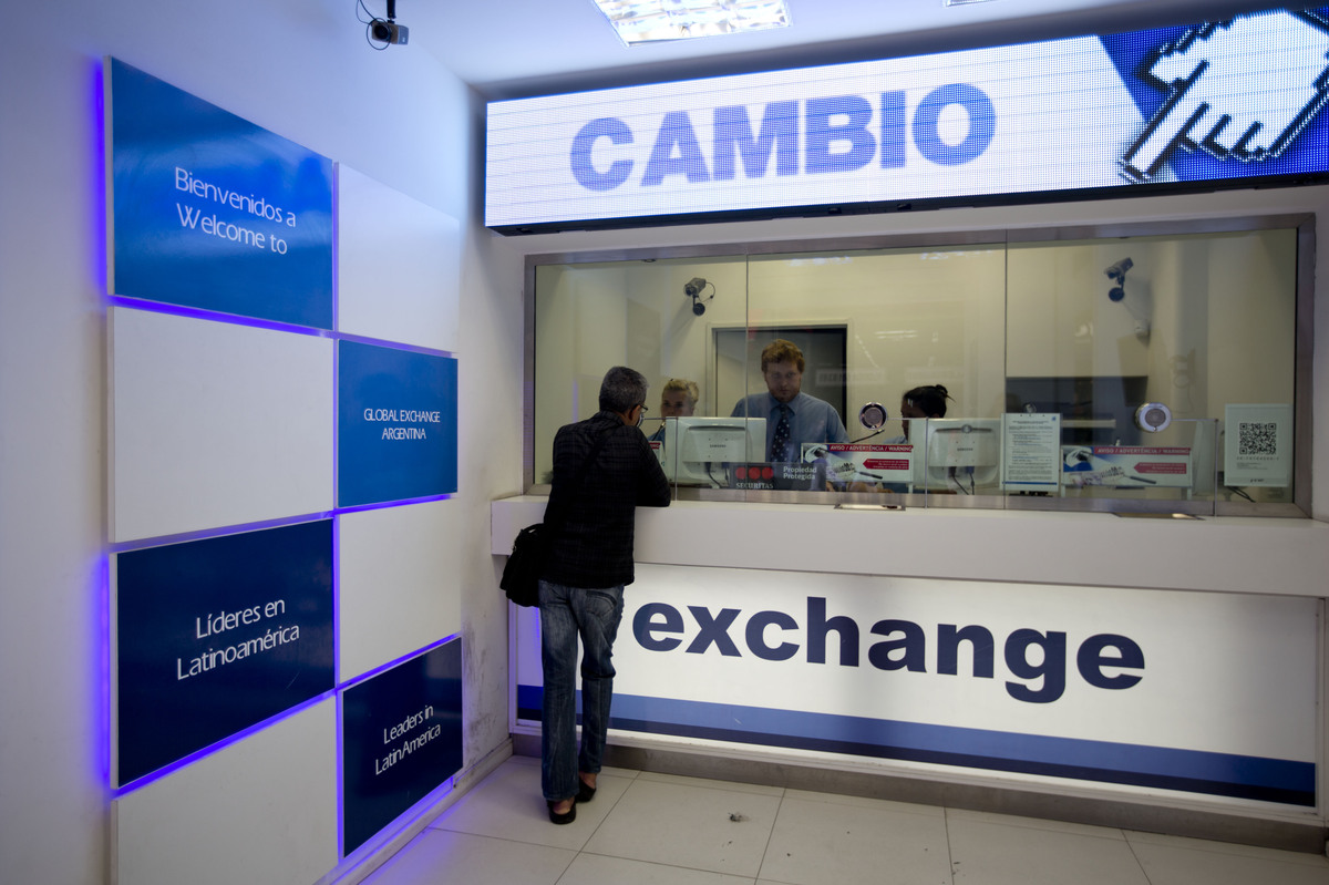A man gets information about how to buy dollars at a foreign exchange business in Buenos Aires, Argentina, on Jan. 27.