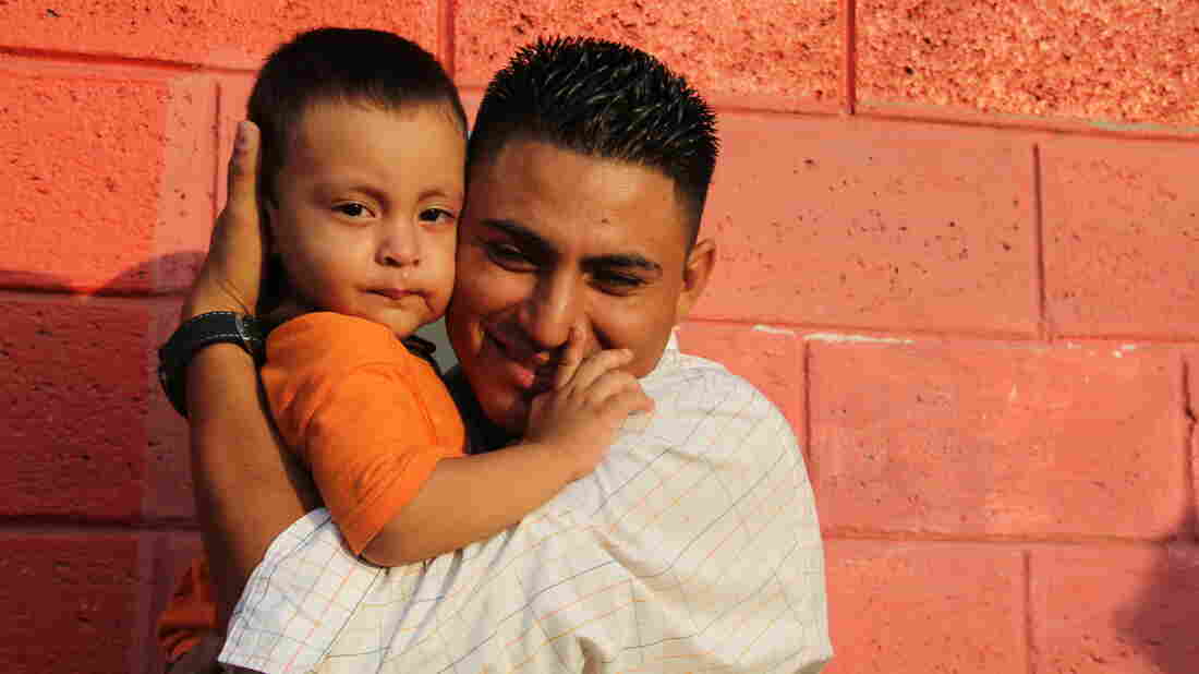 Jose Hernandez greets his young son outside El Edén, the center where deported kids are sent in Honduras. His wife and two young children had just been deported from Mexico.